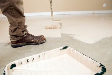 Painter painting garage floor in Forest Grove